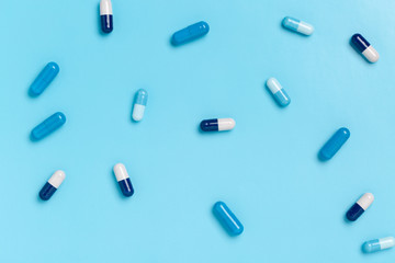 Colorful medicine capsules on a single color background