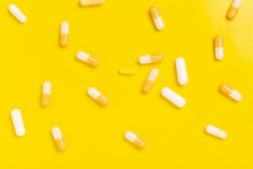 Colorful medicine capsules on a single color background