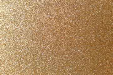 Golden glitter texture. Christmas abstract background. Abstract Bright gold shiny background. Bright halftone pattern. Light paper texture for luxury elegant backdrop design wallpaper or template