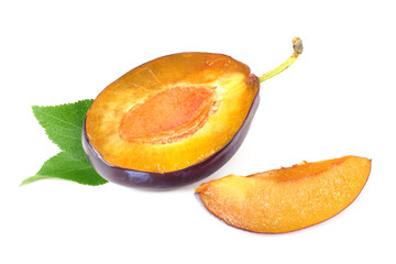 plum slices with green leaves isolated on a white background