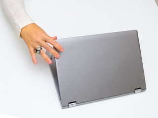 hand of a woman closing a laptop