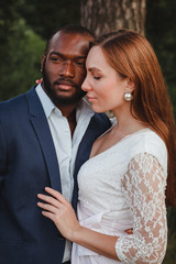 lovely european woman hugs african american man