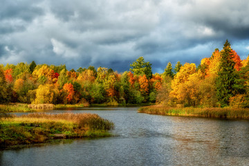 Beautiful autumn landscape with colorful trees by the river.