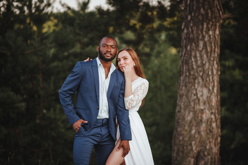 Fototapeta premium young african american man and european woman hugging