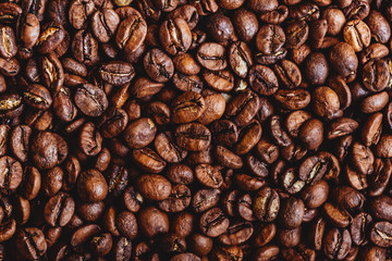 Naklejka premium Coffee grains. Background of roasted coffee beans brown. layout. Flat lay.