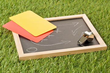 Soccer sports referee chrome whistle with game strategy drawing blackboard and yellow and red...