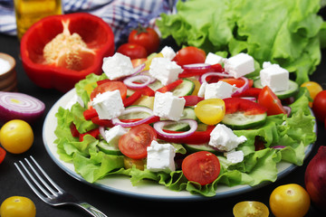 A plate full of bright fresh vegetable salad	