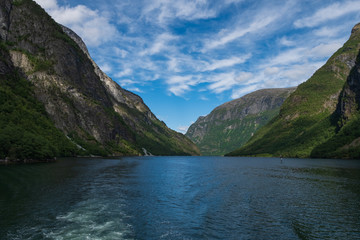 Naklejka na ściany i meble Mountains and Neroyfjord Sognefjord in Norway. Clouds and blue sky. July 2019