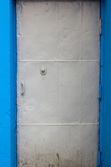 metal gray door in a blue opening