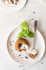 Chocolate dessert decorated with whipped cream, grated chocolate and mint. Traditional Italian dessert panna cotta. Selective focus.