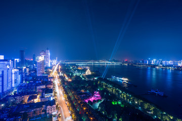 Cityscape of Wuhan city at night, night lights and road traffic along the streets beside yangtze river.