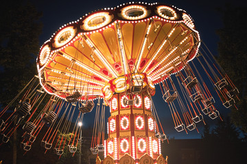 Illuminated swing chain carousel in amusement park at the night © Lazy_Bear