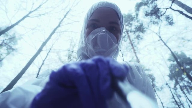 Female forensic scientist using brush to find evidence, collecting fingerprints