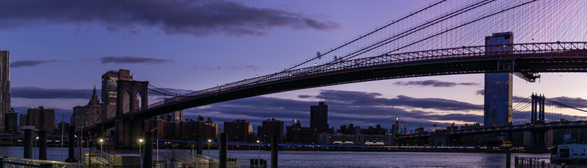 Fototapeta na wymiar Brooklyn Bridge seen from DUMBO, Manhattan on the other side of the east river. Captured during sunrise