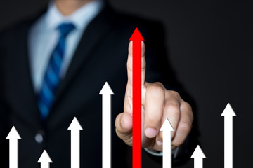 Businessman touching the red arrow pointing up. Development, competition, growth of business...