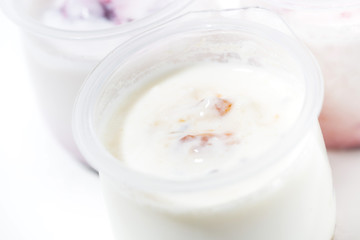 Fototapeta na wymiar assortment of yogurts with fruit additives, closeup top view