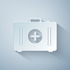 Paper cut First aid kit icon isolated on grey background. Medical box with cross. Medical equipment for emergency. Healthcare concept. Paper art style. Vector Illustration