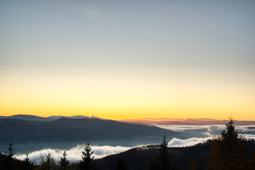 sunrise over mountains with fog in valley