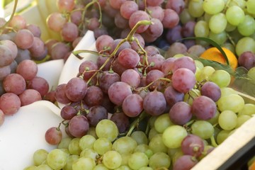 bunches of grapes on display on a market stall
