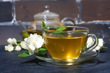 fragrant jasmine tea in a cup on a dark background