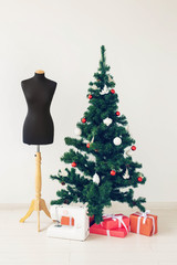 Holidays, clothing design and gift concept - Sewing machine as a present under Christmas tree