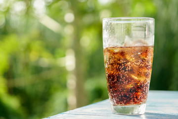 glass of Ice cola with splashing bubbles