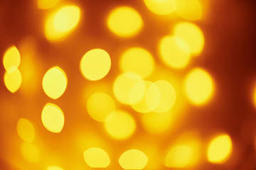 Background of golden lights in a bokeh. Defocused abstract blurred lights