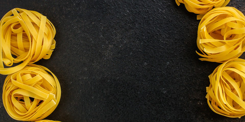 pasta tagliatelle nest, linguine serving food (Bucatini, Fideo or Pappardelle) menu concept. food background. copy space. Top view