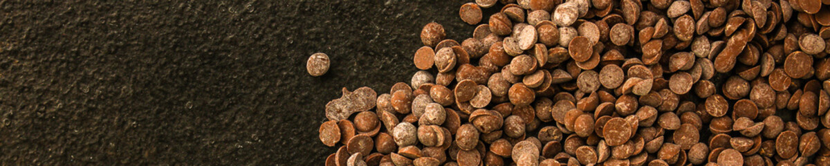 chocolate drops (black or milk chocolate, sweet ingredient) menu concept. food background. copy space. Top view