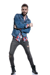 cool fashion guy posing and holding elbow in a fashion pose