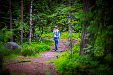 Fototapeta na wymiar Woman on forest road in summer
