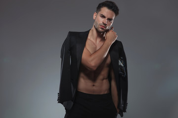 dramatic fashion model holding elbow in a fashion pose
