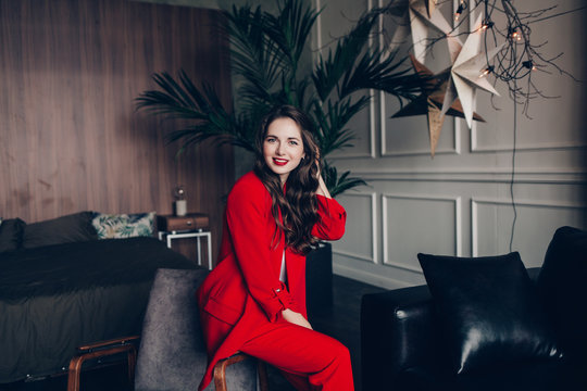 Beautiful Successful Woman In A Red Suit Smiling