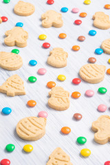 Christmas different shaped cookies and multi-colored sweets on a light gray background