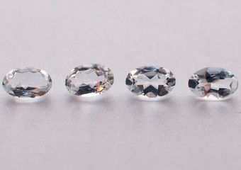 Natural white oval faceted aquamarines on the white background
