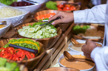 Obraz premium Food Buffet Catering Dining Eating Party Sharing Concept.people group catering buffet food indoor in luxury restaurant with meat colorful fruits and vegetables