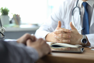 Close-up of doctor and patient hands while doctor listens to patient complaints. Male doctor giving a consultation to a patient and explaining medical information and diagnosis - 301813912