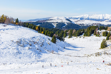 Fototapeta na wymiar Lessinia natural park covered with snow, mountain of northern Italy at winter beginning of the snow