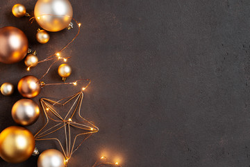 Brown background with golden Christmas balls and Christmas lights