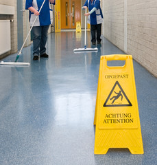 Cleaning. Cleaning woman. Wet floor sign. 
