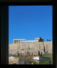 Athens Greece, blue sky over Parthenon ancient temple through a window frame