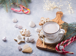 Hot chocolate cacao drinks with gingerbread  in Christmas white mug on grey background. Traditional...
