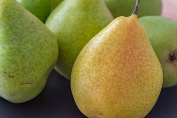 Some pears. The focus is on the pear in foreground.