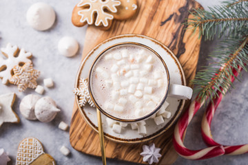 Hot chocolate cacao drinks with marshmallows in Christmas color mugs on grey background. Traditional hot beverage, festive cocktail at X-mas or New Year