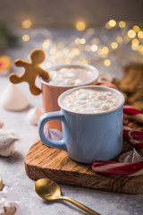 Hot chocolate cacao drinks with marshmallows in Christmas mugs on grey background. Traditional hot beverage, festive cocktail at X-mas or New Year