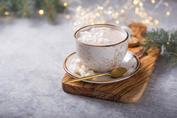 Hot chocolate cacao drinks with marshmallows in Christmas mug on grey background. Traditional hot beverage, festive cocktail at X-mas or New Year
