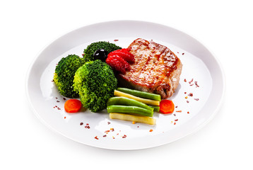 Grilled steak with vegetables on white background