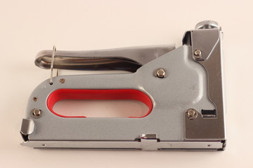 New portable furniture stapler closeup on white background