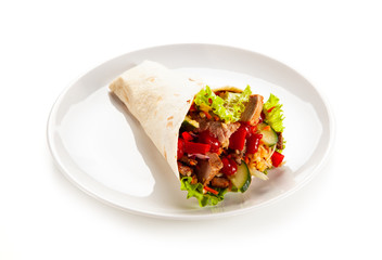 Kebab - grilled meat and vegetables wrapped in tortilla
