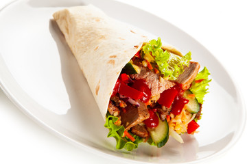 Kebab - grilled meat and vegetables wrapped in tortilla